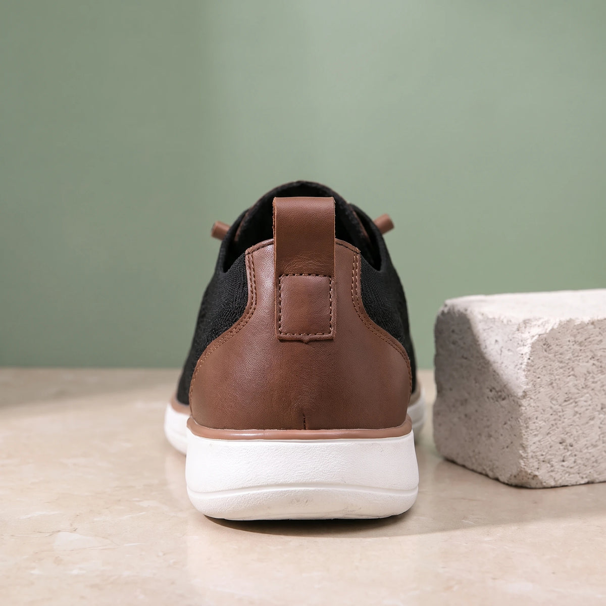 Close-up of the brown heel tab and white sole