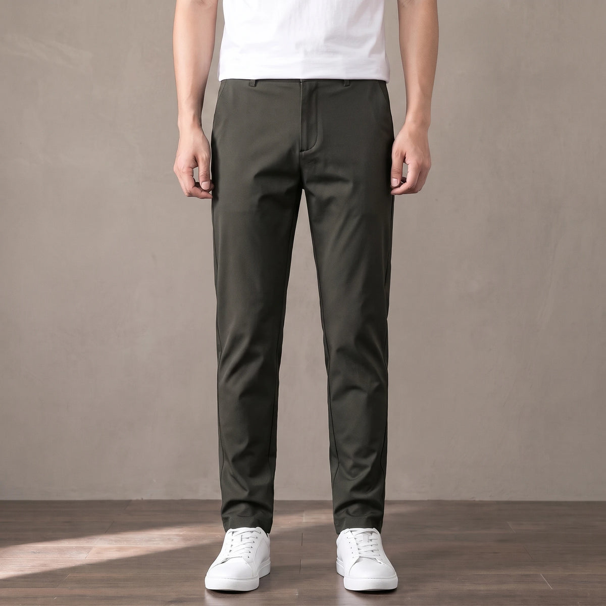 army green tapered trousers worn with a white tee and white trainers