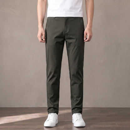 army green tapered trousers worn with a white tee and white trainers
