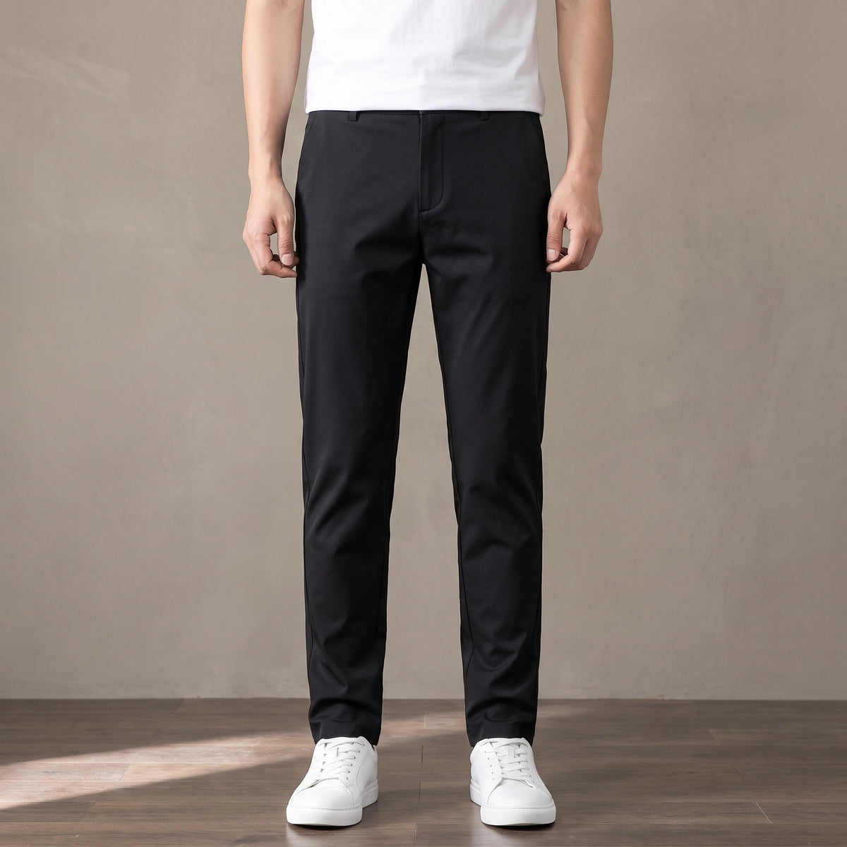 black tapered trousers worn with a white tee and white trainers