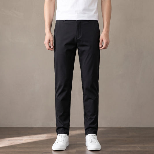 black tapered trousers worn with a white tee and white trainers