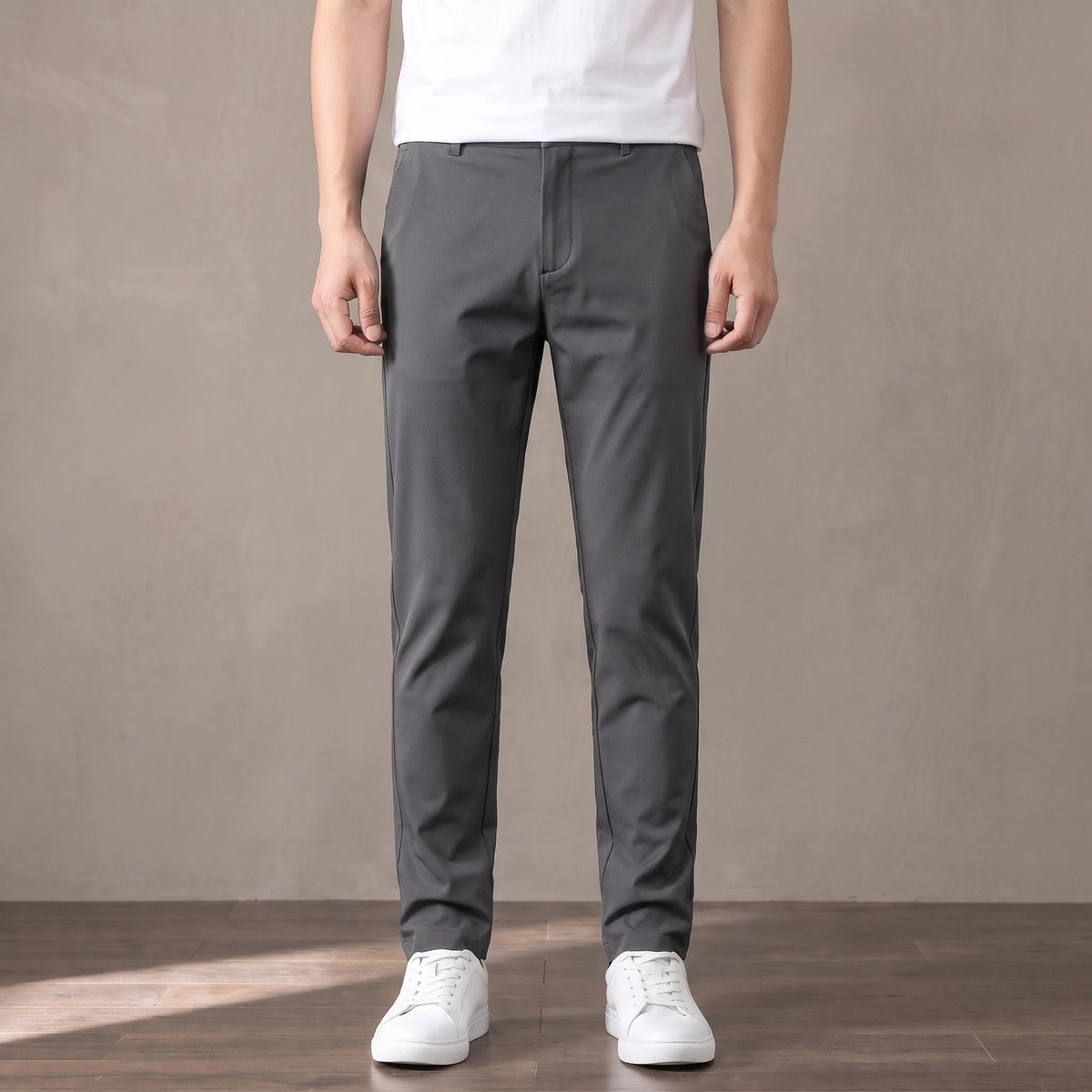 dark grey tapered trousers worn with a white tee and white trainers