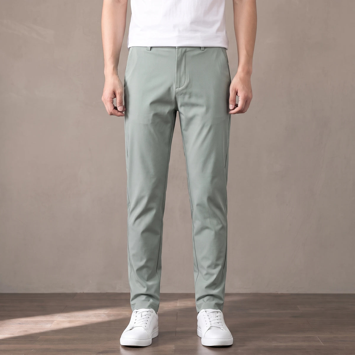 light green tapered trousers worn with a white tee and white trainers