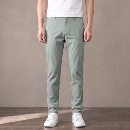 light green tapered trousers worn with a white tee and white trainers