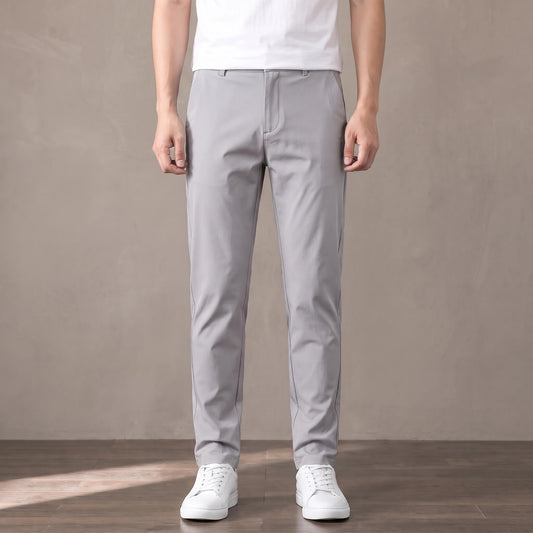 light grey tapered trousers worn with a white tee and white trainers